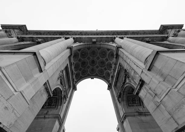 Arc de Triomphe, Brussels, Belgium. Les Arcades du Cinquantenaire from 1905 seen from below. Jubilee Park. Tribute to the 50th anniversary of Belgian independence. Black and white image.