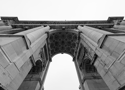 Arc de Triomphe, Brussels, Belgium. Les Arcades du Cinquantenaire from 1905 seen from below. Jubilee Park. Tribute to the 50th anniversary of Belgian independence. Black and white image.
