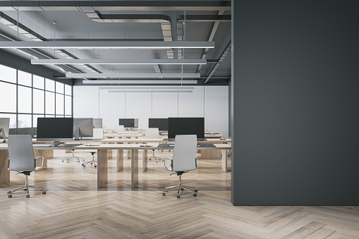 Modern concrete coworking office interior with wooden flooring, window and city view, empty mock up place on wall, furniture and equipment. 3D Rendering