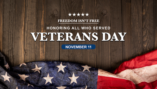 Veterans day - November 11 theme banner with United States of America blag on wood table.