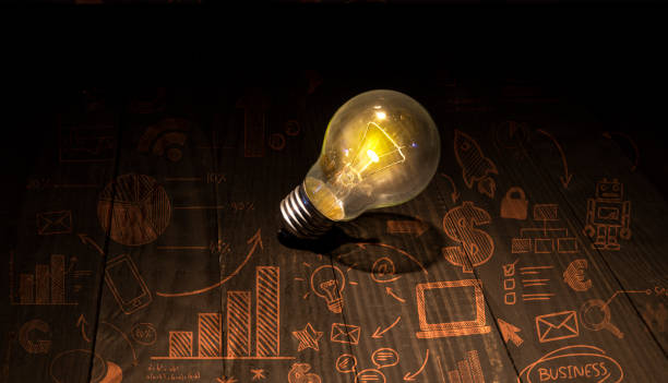 istock Startup idea doddle icons with light bulb on wooden table 1439998414