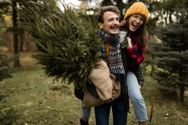 istock Happy couple having fun on their Christmas tree adventure 1439998628