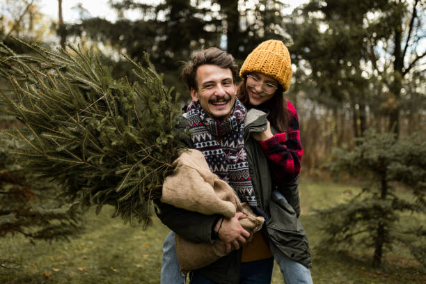 istock Happy couple having fun on their Christmas tree adventure 1439998842
