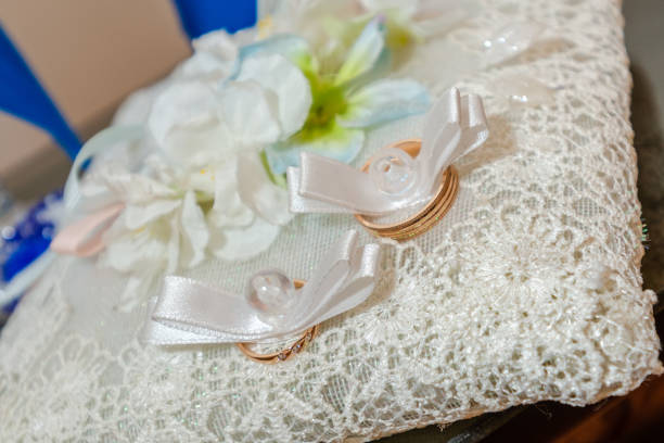 istock Two gold wedding rings on white pillow 1439998861