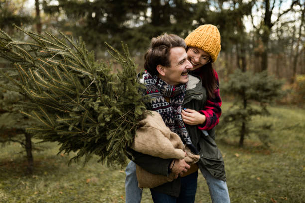 istock Happy couple having fun on their Christmas tree adventure 1439998901