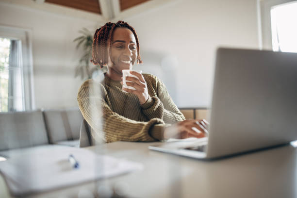 istock Woman working at home on laptop and drinking coffee 1439999312