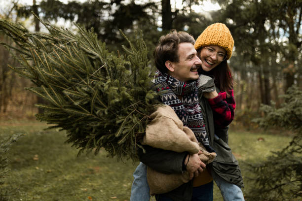 istock Happy couple having fun on their Christmas tree adventure 1439999395