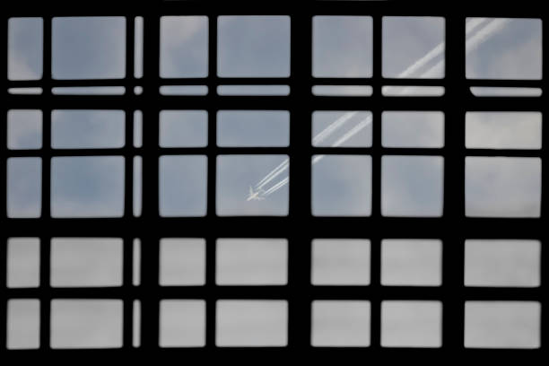 The plane behind the airport window