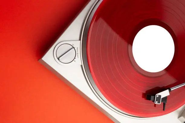 a bright red music lp record on a turntable