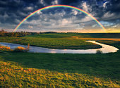 Landscape with a Rainbow on the River in Spring. colorful morning. nature of Ukraine