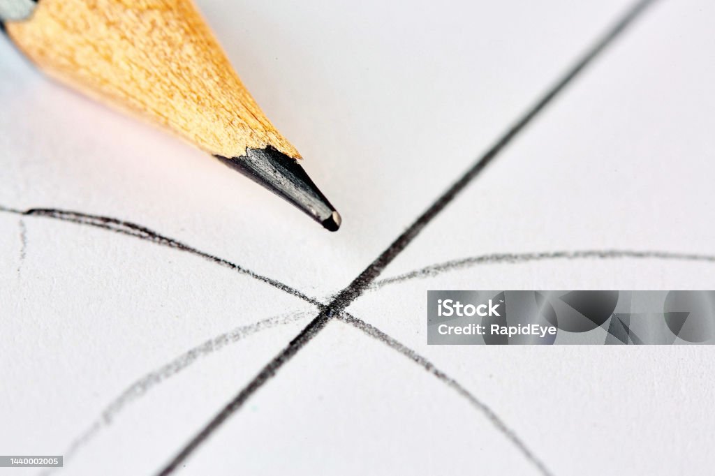 Extreme close-up of a wooden pencil with geometric curves and lines drawn on paper Geometry close-up, with compass-drawn curves and a straight line. Graphite Stock Photo