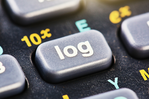 Macro shot of the keypad of a scientific calculator, emphasising the log key.