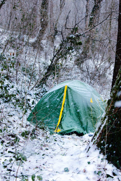 istock Tent is covered with snow, overnight hikers in forest 1440002420