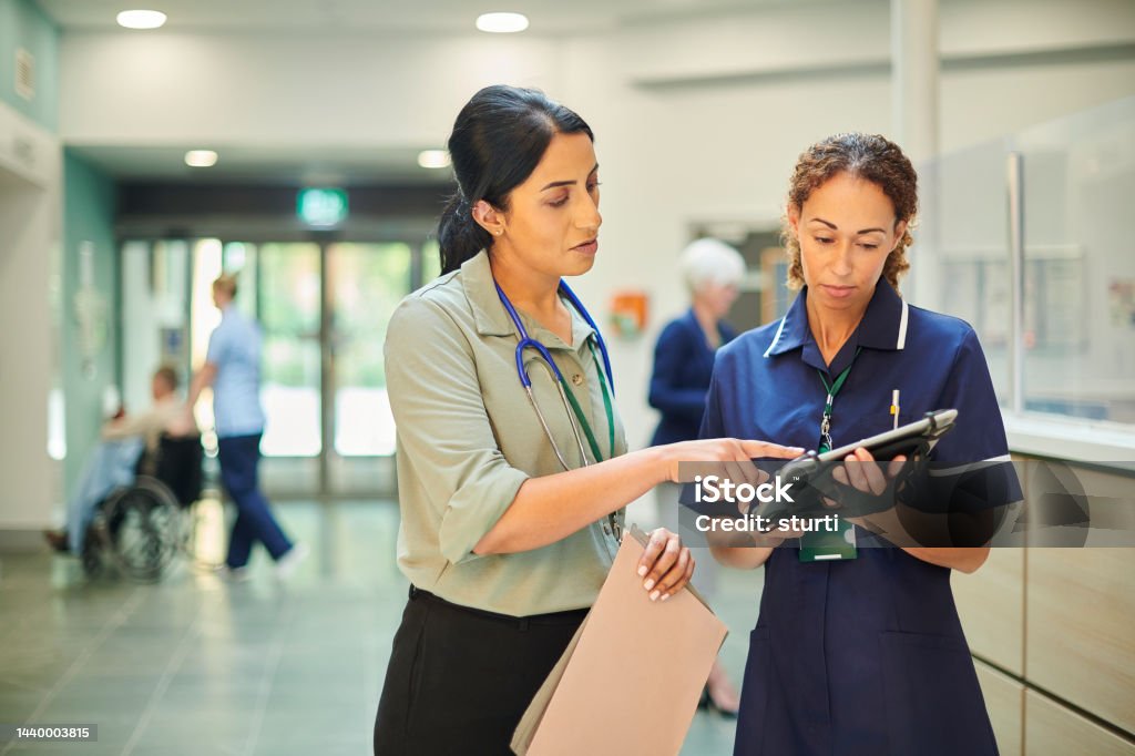 hospital colleagues checking medical records database staff nurse consulting ward doctor Healthcare And Medicine Stock Photo