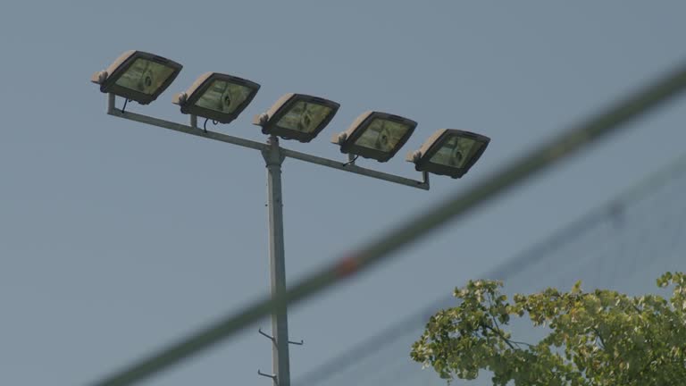 Stadium lights against a blue sky