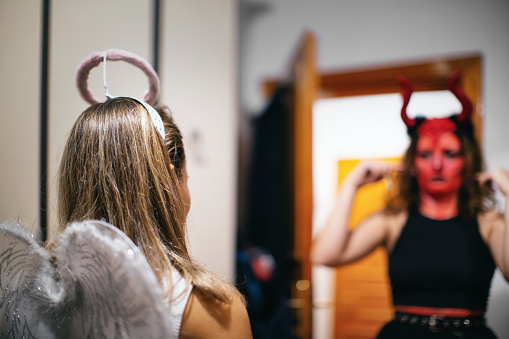 Woman preparing for Halloween party before going out.