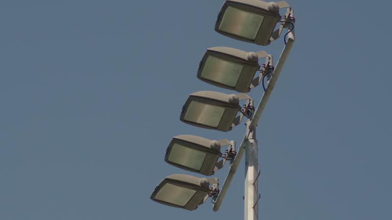 Stadium lights against a blue sky