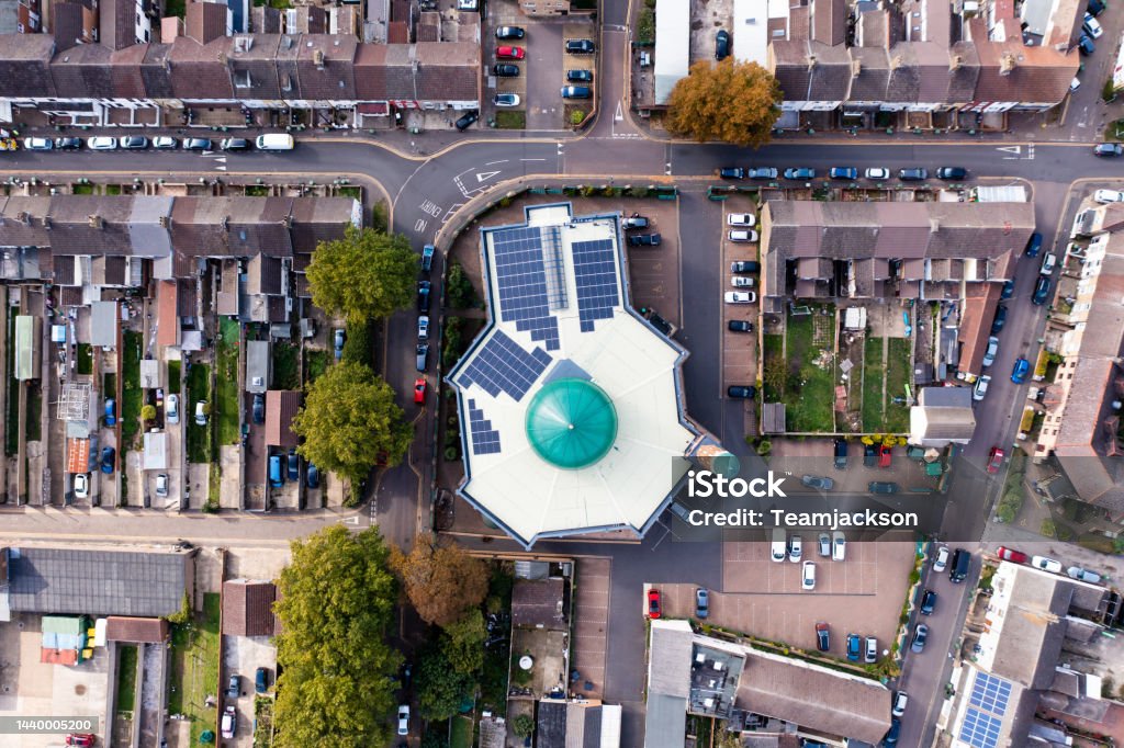 Aerial view directly above a local community Mosque in the UK Aerial view of a Muslim neighbourhood in a UK city with a Mosque at the center City Stock Photo
