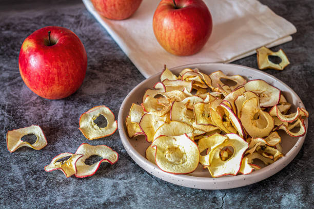 istock Dried organic apple slice chips in bowl 1440005636