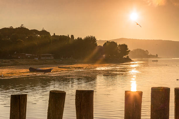 Trasimeno lake, Umbria, Italy - October 17, 2022: View of the lake at sunrise in early morning mist