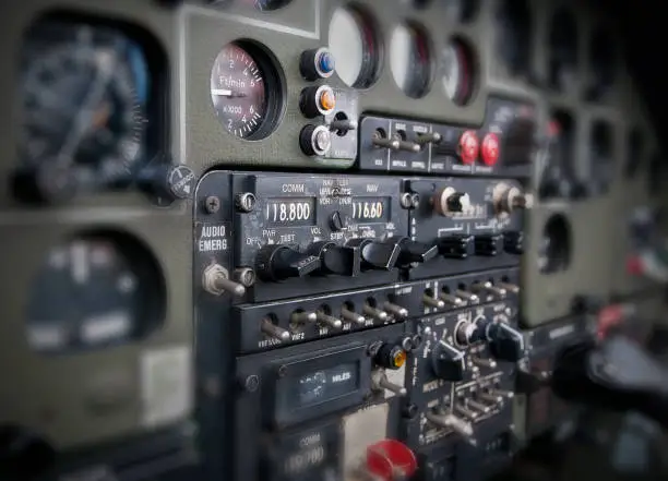 A view of the cockpit of a military helicopter. (switches, gauges, controllers)