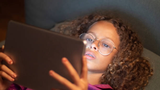 istock Portrait of cute girl using digital gadget 1440010376