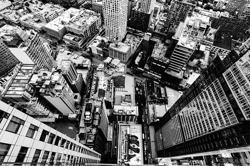 An aerial grey scale shot of the buildings and streets in New York City, United States