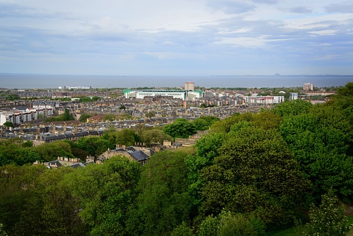 A scenic shot of trees and buildings in the city of Edinburgh in Scotland