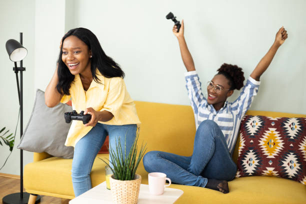 istock Two African American roommates gaming and cheering 1440011750