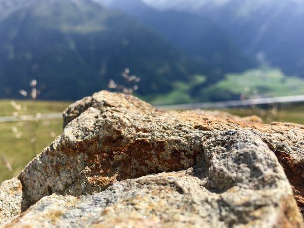 istock Closeup view from a stone wall to the mountains and greenery under the sunlight during daytime 1440011775