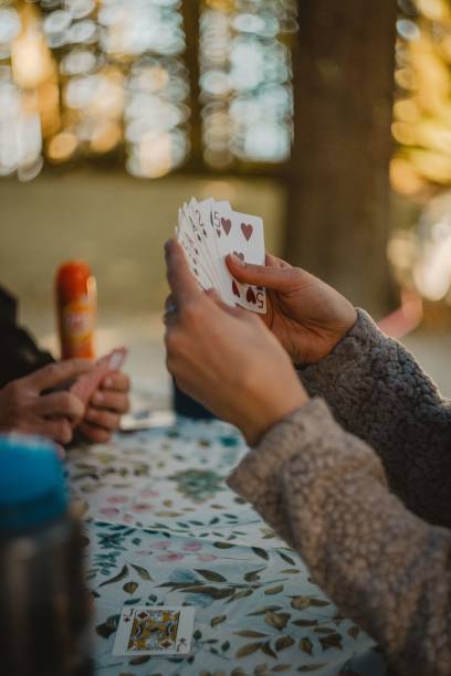 istock People playing cards in a forest while camping outside at a picnic table 1440012146