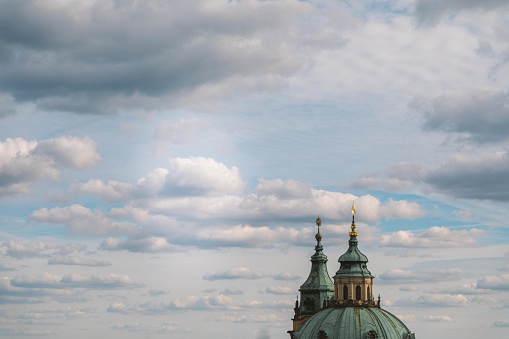 A beautiful shot of a chapel with domes under the cloudy sky in Prague, Czech Republic