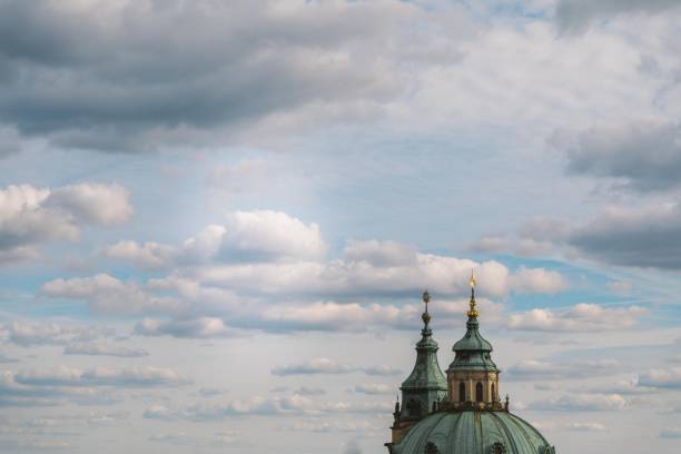 Beautiful shot of a chapel with domes under the cloudy sky in Prague, Czech Republic A beautiful shot of a chapel with domes under the cloudy sky in Prague, Czech Republic prague art stock pictures, royalty-free photos & images
