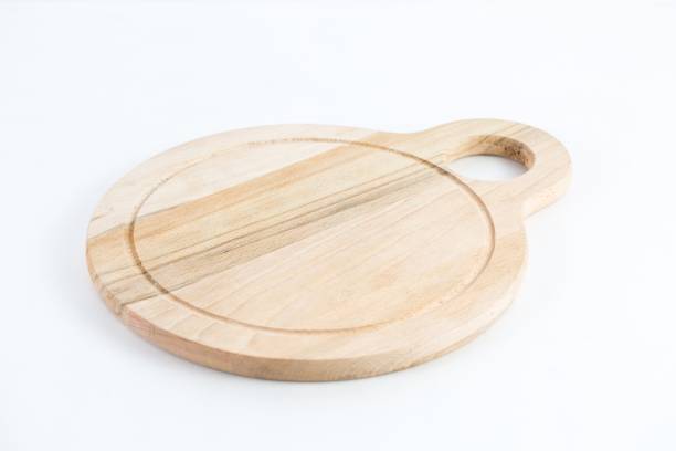 istock Round-shaped wooden chopping board isolated on a white background 1440013652