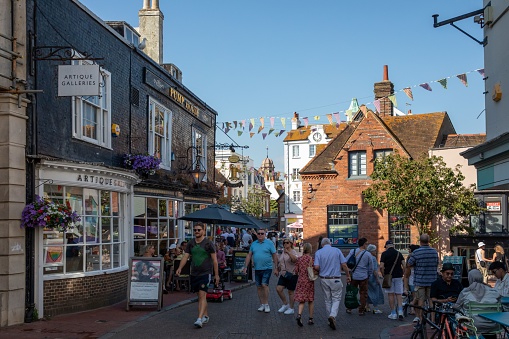 Brighton, United Kingdom – July 29, 2022: The people walking in a popular shopping area with beautiful architectures of Brighton city in UK