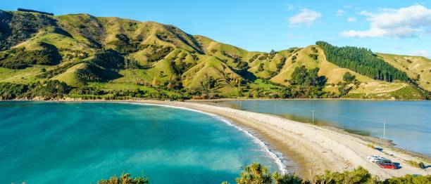 istock Aerial view of lake surrounded by greenery mountains with dense trees 1440015082