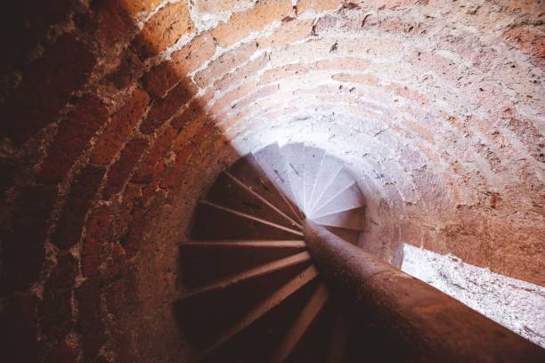 Overhead shot of a spiral staircase in a brick tower An overhead shot of a spiral staircase in a brick tower accomodating stock pictures, royalty-free photos & images