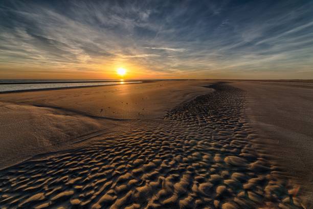 istock Beautiful sunset at the beach creating the perfect atmosphere for an evening walk 1440016037