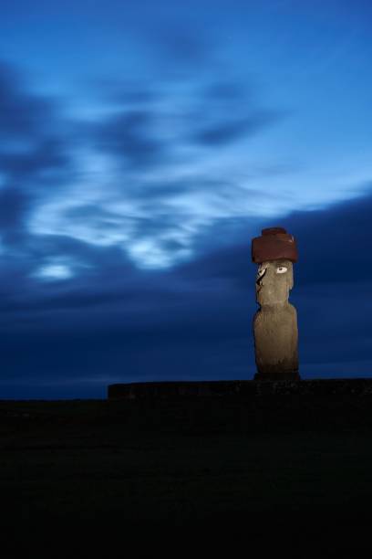 istock Ancient Polynesian statue in the Ahu Ko Te Riku at night, Easter Island,  Chile, vertical 1440016165
