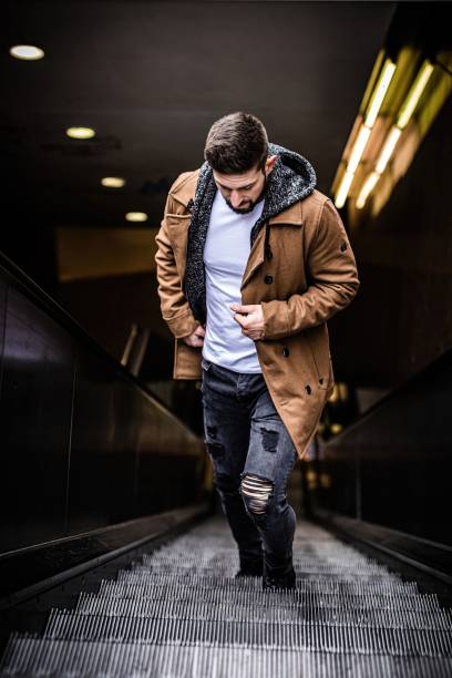 istock Man walking slow on steps up from underground to city while standing on electric stairs 1440016493