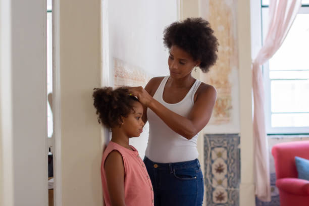 istock African American woman measuring daughters height 1440017232