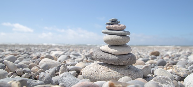A beautiful shot of a stack of rocks on the beach - business stability concept