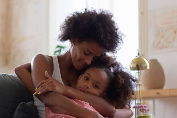 istock African American mother and daughter hugging lovingly 1440017276