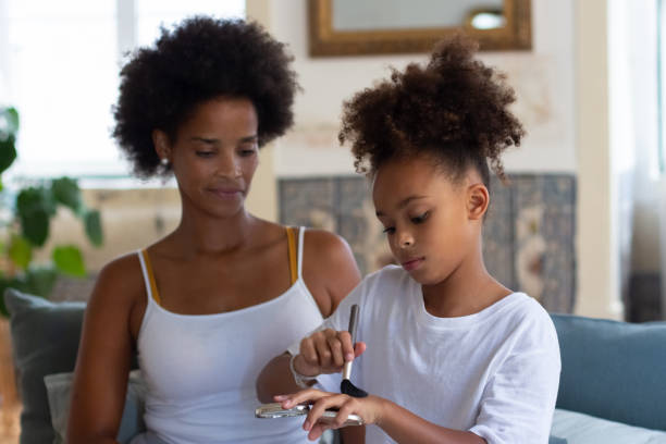 istock African American mother teaching daughter how apply makeup 1440017292
