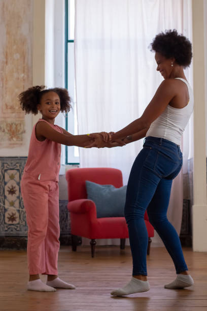 istock Happy African American mom daughter dancing 1440017394