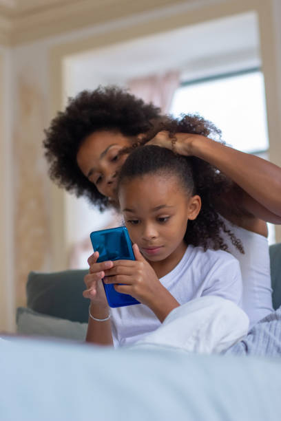 istock Helpful mother brushing daughters hair 1440017431