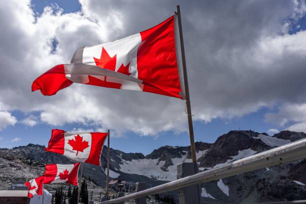 breathtaking shot of canadian flags flying at top of whistler mountain, bc, canada - canadian flag fotos imagens e fotografias de stock