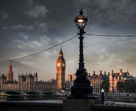 A beautiful closeup shot of streetlight in front of the Big Ben and the House of Parliament on a cloudy day