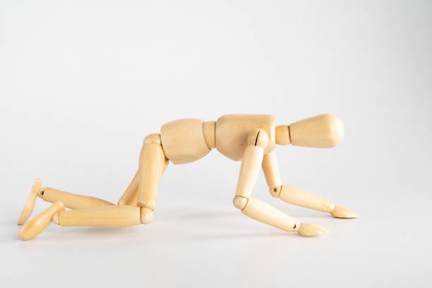 istock Wooden pose doll posed like crawling on a white background 1440018133