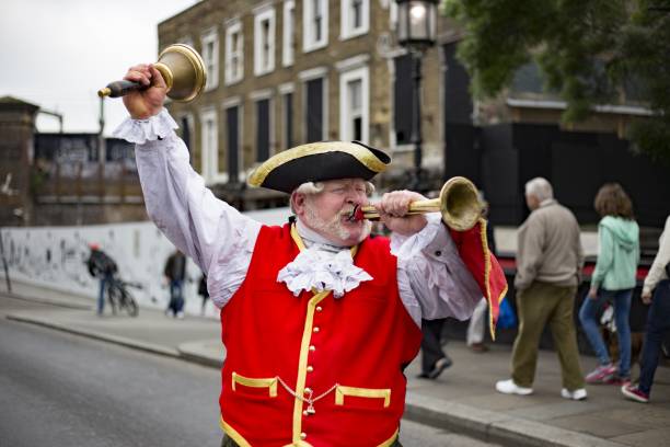 Town Crier London, United Kingdom – May 30, 2016: Traditional town crier bellows out the news of events in Camden Market town criers stock pictures, royalty-free photos & images